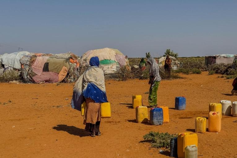  Au point de distribution d'eau du camp de déplacés de Rasqabobe, dans la région de Mudug, en Somalie, les habitants remplissent des jerrycans.