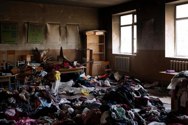 À l'intérieur de l'école incendiée de Maksat. Des tonnes d'aide humanitaire ont été envoyées par des personnes solidaires de Bichkek à Batken. Parmi cette aide, beaucoup de vêtements ne pouvaient pas être portés par les locaux car jugés trop légers selon les coutumes conservatrices du sud. Ils ont été jetés dans une salle de classe incendiée.
 
 © Maxime Fossat